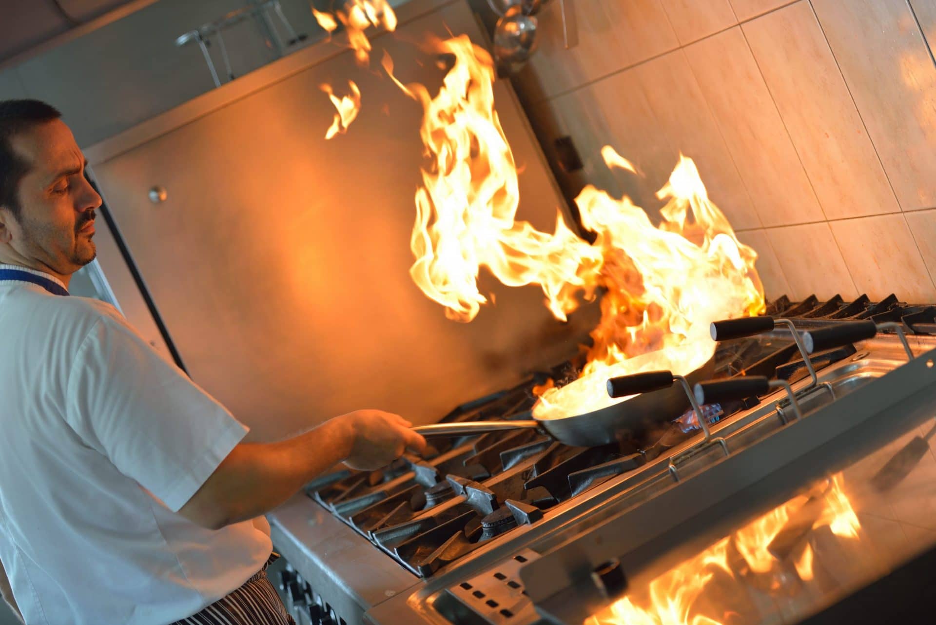 chef with flame on stove