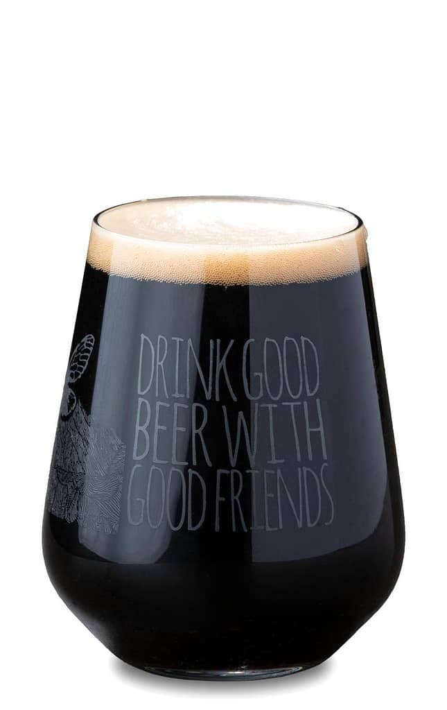 Ballhoot Black IPA beer in a glass. The glass says "drink good beer with good friends"