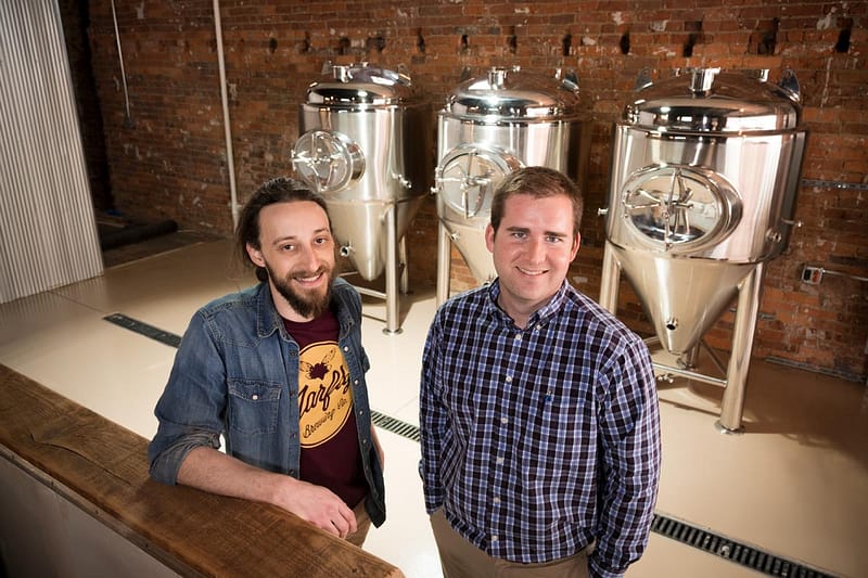Daniel and Delany inside Jarly Brewery with new stainless steal brewing tanks in the background.
